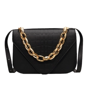 Chic black crocodile embossed crossbody bag with chunky gold chain strap and V-flap
