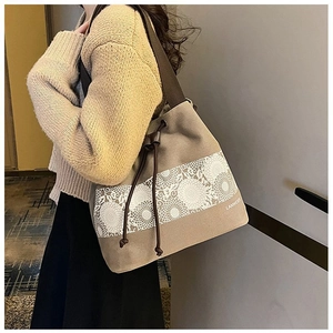 Detail of canvas bucket bag featuring floral lace print and drawstring closure design