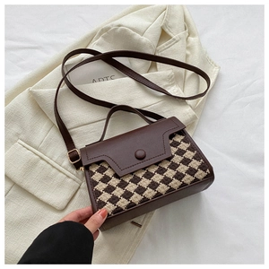 Detail der Vintage-Hahnentritt-Handtasche mit Kunstlederklappe und runder Schnalle