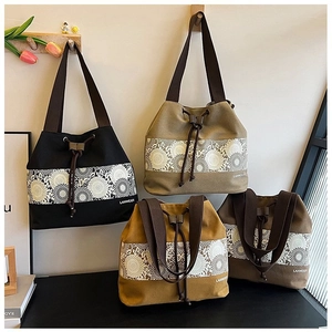 Detail of canvas bucket bags featuring lace sunflower patterns and drawstring closure
