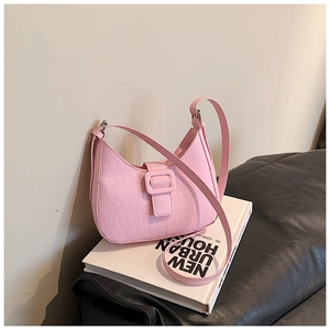 Close-up of pink faux crocodile texture shoulder bag with stylish square buckle detail