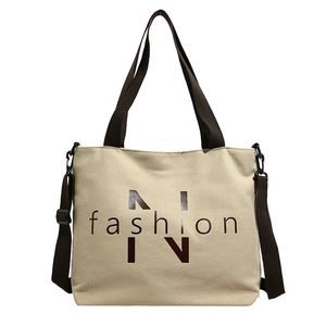 Casual canvas tote bag with brown shoulder straps and stylish front print for daily commuting.