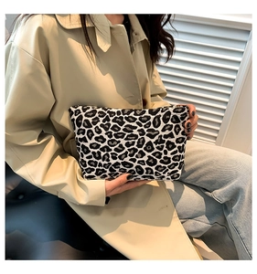 Close-up of leopard print clutch bag with zipper in high-quality woven canvas fabric