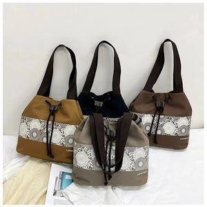 Detail view of four large canvas tote bags with drawstring closure and floral lace trim