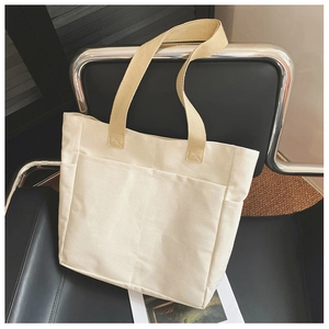 Détail du sac fourre-tout en toile avec sangles kaki et poche frontale de rangement