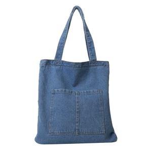 Blue denim tote bag with dual front pockets and shoulder straps for daily fashion