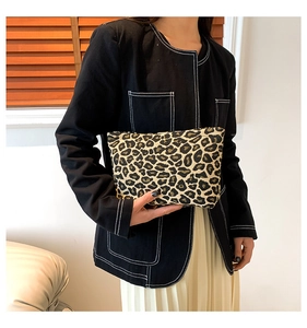 Macro shot of stylish leopard print handbag with thick fabric texture and zipper detail