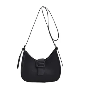 Minimalist black faux crocodile saddle bag with resin buckle and adjustable strap