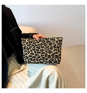 Detailed view of the leopard print clutch bag made of high-quality jacquard fabric texture