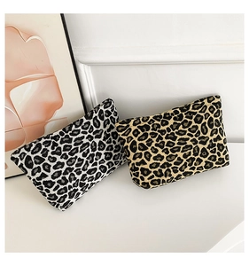 Detailed close-up of leopard print canvas pouches in black-white and yellow-black tones