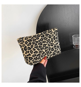 Close-up of leopard print handbag with canvas texture and premium gold zipper detail