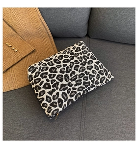 Macro shot of stylish leopard print fabric texture and zipper on this rectangular clutch bag