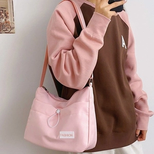 Pink minimalist nylon crossbody bag with fashion label and white drawstring detail