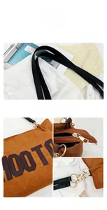Detail of brown felt tote bag with gold zipper closure and stylish metal chain link