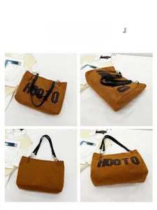 Detail view of brown corduroy tote bag showing metal ring and black leather strap