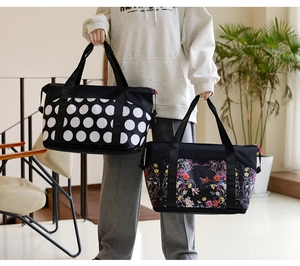 Detail of large travel bags with polka dot and floral prints on durable nylon fabric