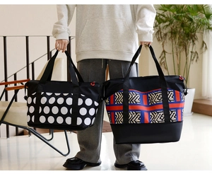 Close-up of large travel bags with polka dot and geometric prints in a lifestyle setting