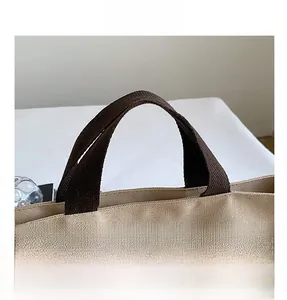 Close-up of durable canvas tote bag handle stitching and premium fabric texture