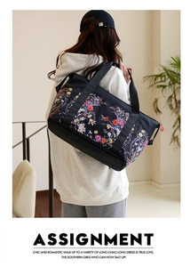 Macro detail of high-capacity printed travel bag with bottom shoe compartment and floral design