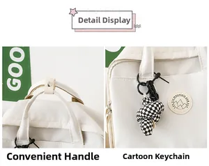 Detail of off-white backpack featuring metal snap handle and checkered charm accessory