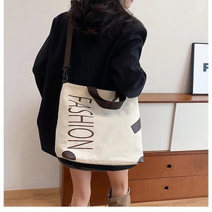 Detail of canvas tote bag with brown fashion print and adjustable shoulder straps