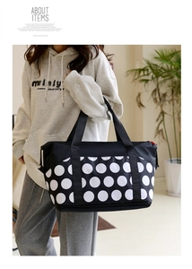 Detail of a large capacity waterproof travel bag with white polka dots for fitness and yoga