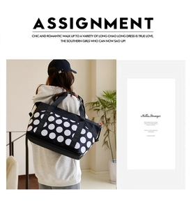 Polka dot travel bag worn by model, showing large capacity and stylish carry strap