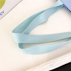 Detailed macro view of mint green woven handle with high density fiber texture on shoulder bag