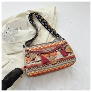 Detailed shot of ethnic diamond pattern and fringes on bohemian canvas shoulder bag