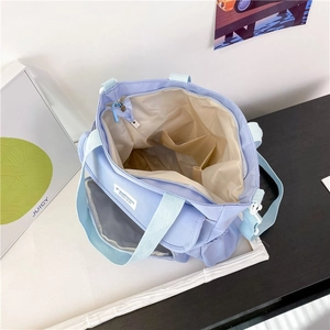 Top view of blue canvas tote bag showing inner compartments and multiple storage pockets
