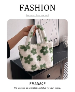 Detail of soft plush tote bag with green floral pattern on white faux fur material