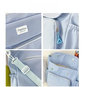 Close-up of light blue shoulder bag details with Fashion label and adjustable strap
