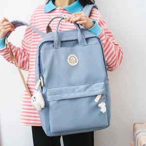 Minimalist light blue large capacity backpack with cute plush puppy charm for students
