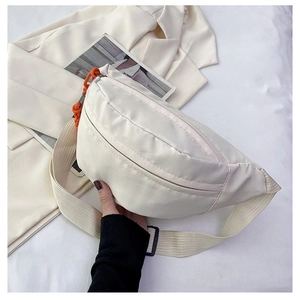 Detail of off-white crescent crossbody bag with orange chain and adjustable wide strap