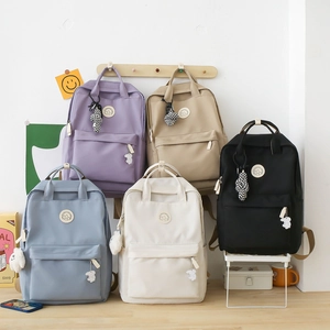 Minimalist large capacity nylon backpacks in five colors with cute charms for students