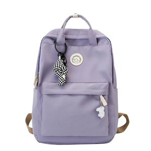 Minimalist lavender nylon backpack for women with spacious pockets and cute pendants