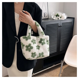 Close-up of fluffy faux fur tote bag with green flower pattern and comfortable handle