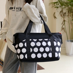 Large capacity black travel bag with white polka dots for yoga and fitness use