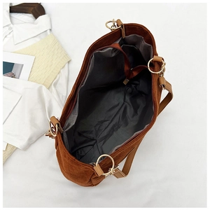 Detailed interior view of a brown corduroy tote bag showing large capacity and zipper pocket