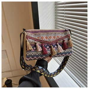 Ethnic bohemian crossbody bag with colorful geometric patterns and decorative tassels