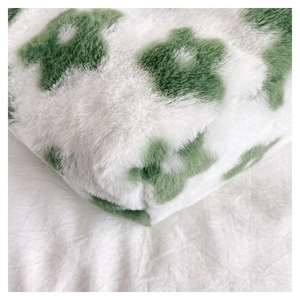 Close-up of soft white plush flower handbag featuring premium green floral fur texture