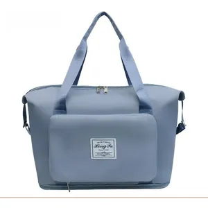 Front detail of large capacity travel tote bag with zipper pocket in dusty blue