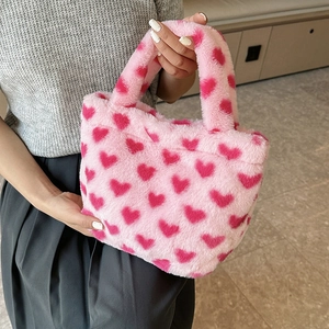 Pink plush handbag with red heart patterns and soft faux fur material for women