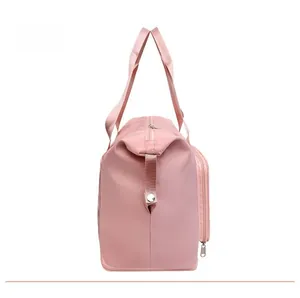 Side view of pink nylon travel bag showing durable handles and metal buckle details
