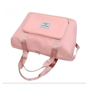 Top view of pink travel duffel bag showing double zippers and reinforced handles