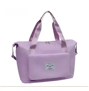 Detail view of lavender travel bag with double handles and zipper expansion layer