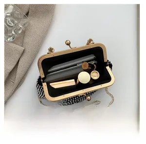 Detail showing the internal capacity of the black rhinestone clutch bag with gold chain