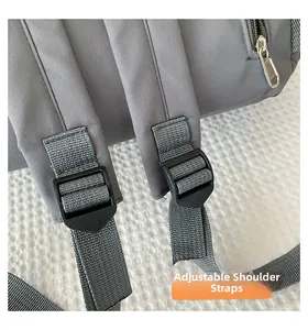 Detail view of adjustable shoulder strap and plastic buckle on nylon backpack