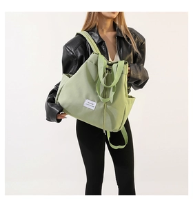 Detailed shot of the light green nylon drawstring bag with the fashion leisure label