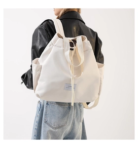 Detail view of large nylon backpack showing side pocket and durable fabric texture